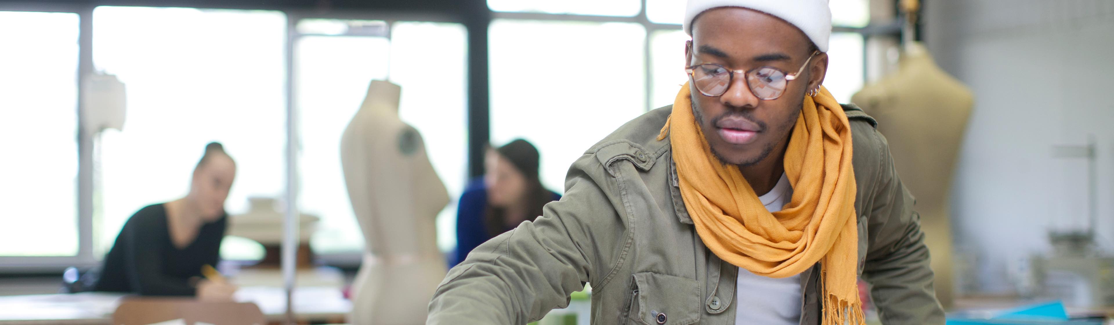 A young South African man working on clothing