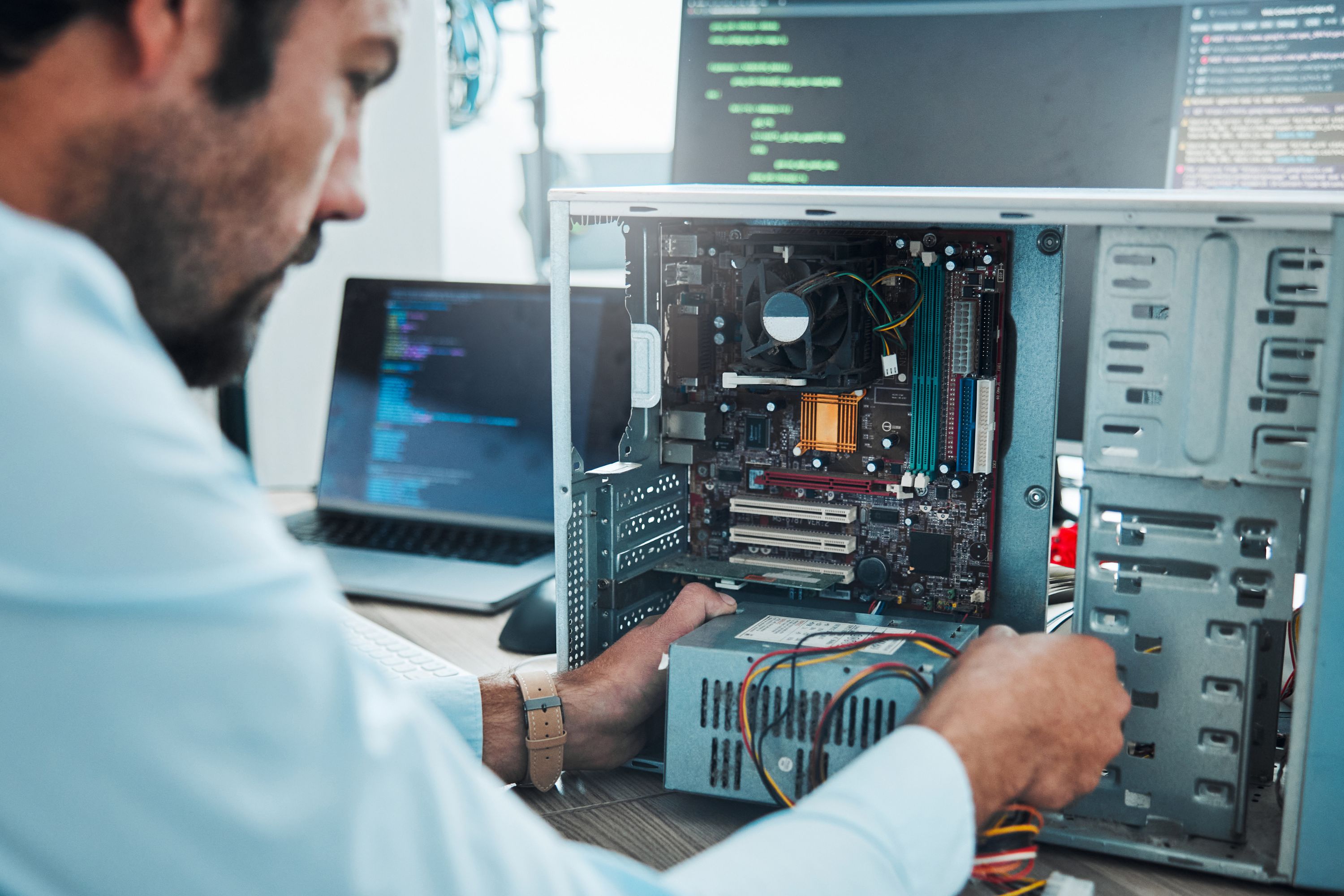 Man looking inside open harddrive