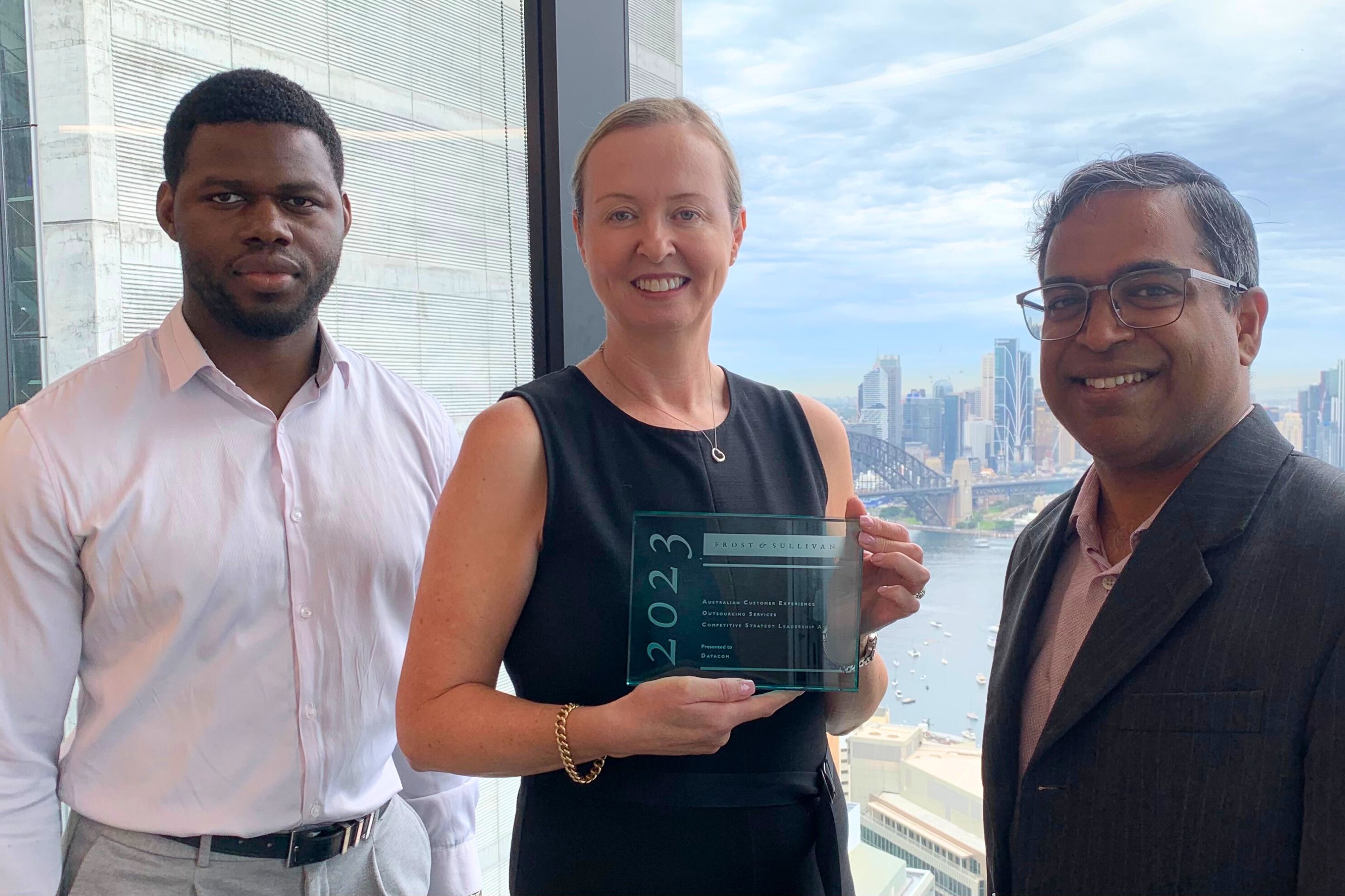 Photograph of Adele Sheers standing in between Victor Eminefo and Ivan Fernandez from Frost & Sullivan