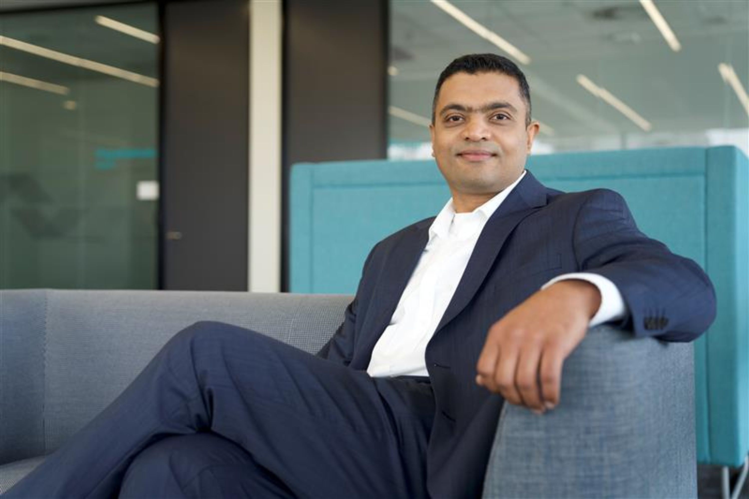 Raghu Hedge sitting on a couch