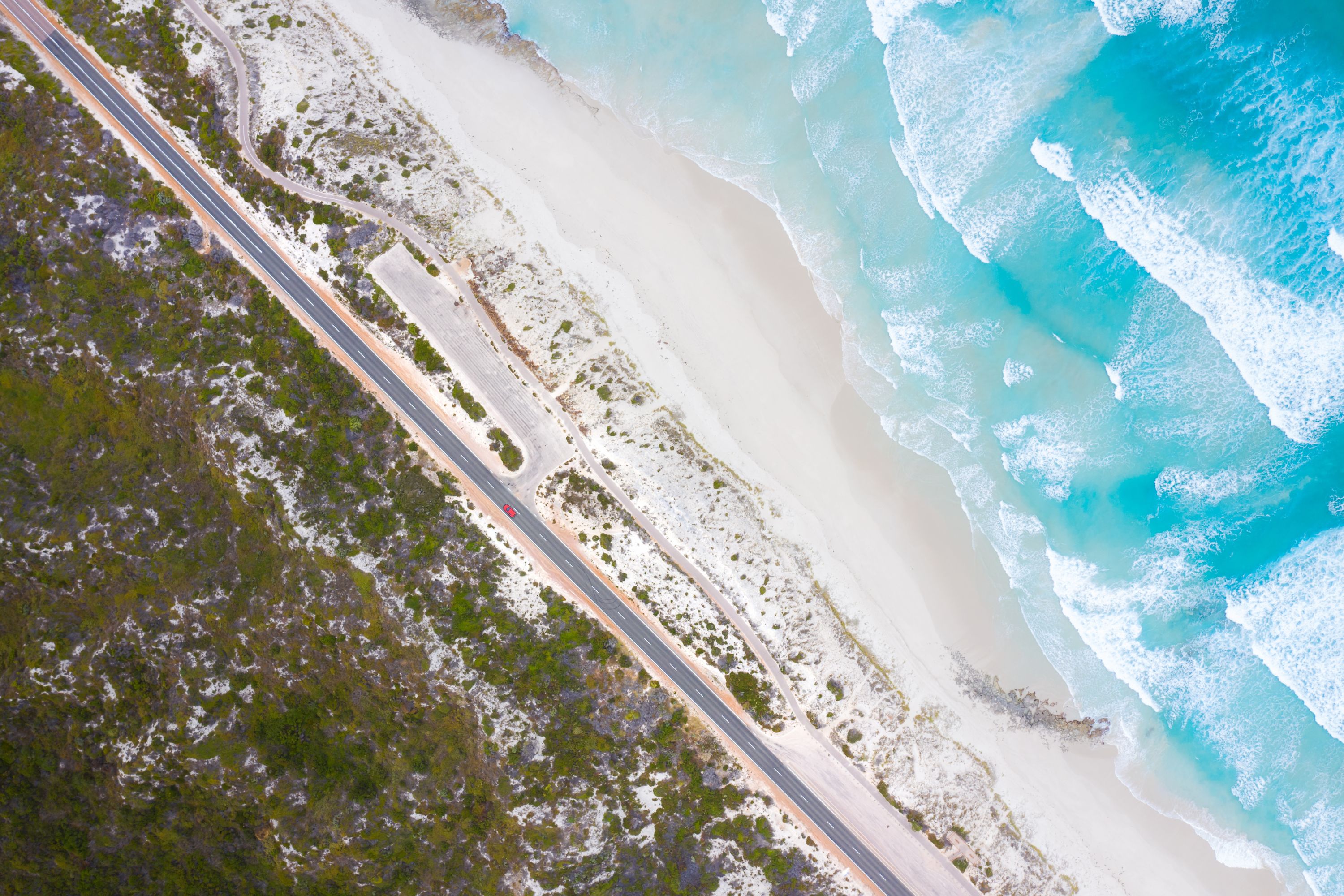 An aerial view of a road running a long side the coastline of Western Australia