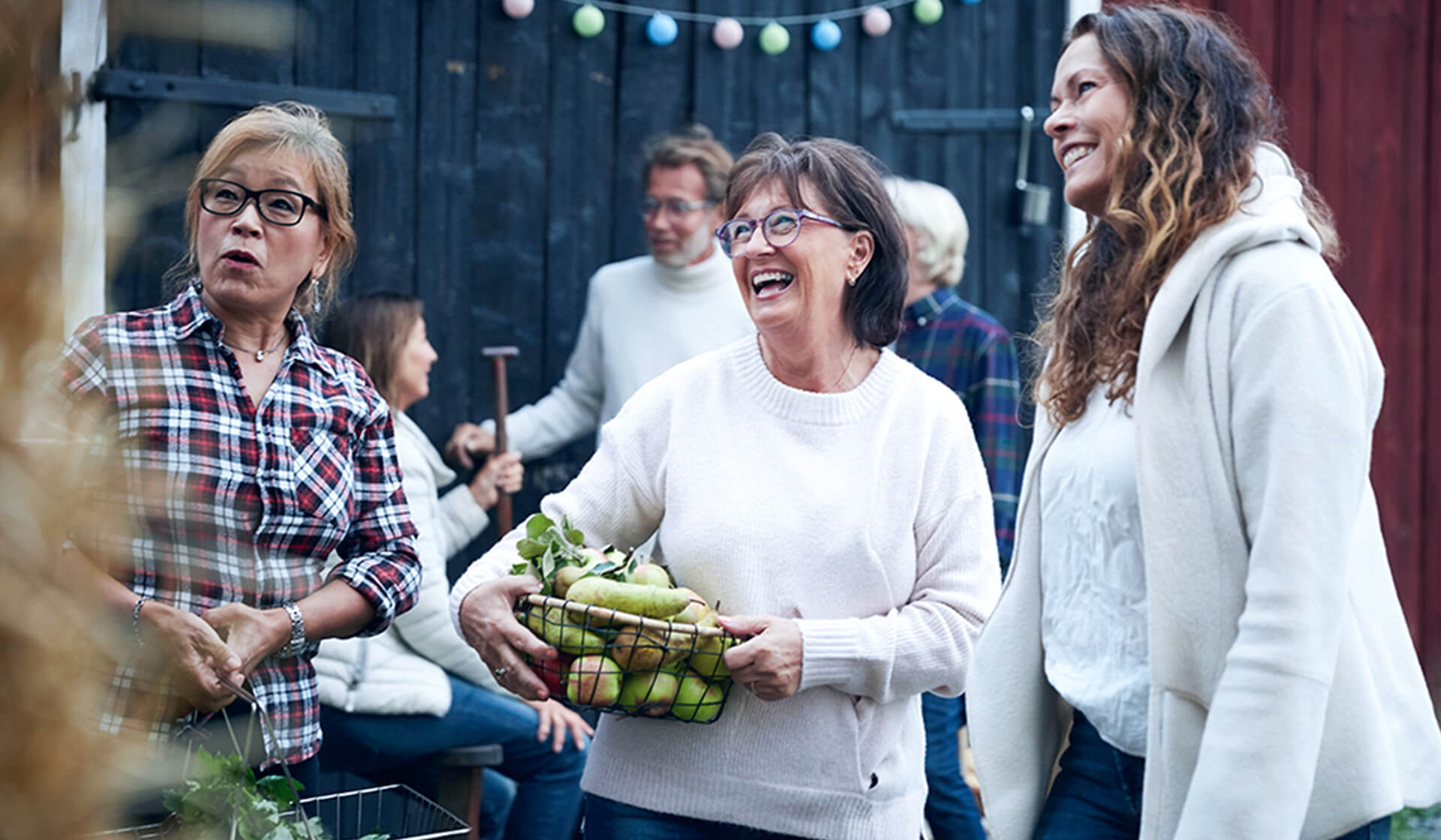 Three women smiling at a farmers market