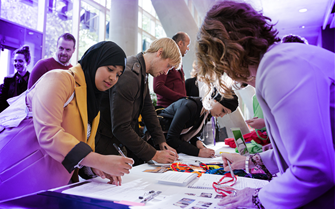 Group of people signing forms