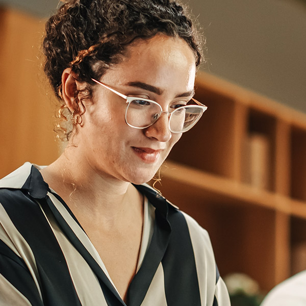 A woman smiling looking down