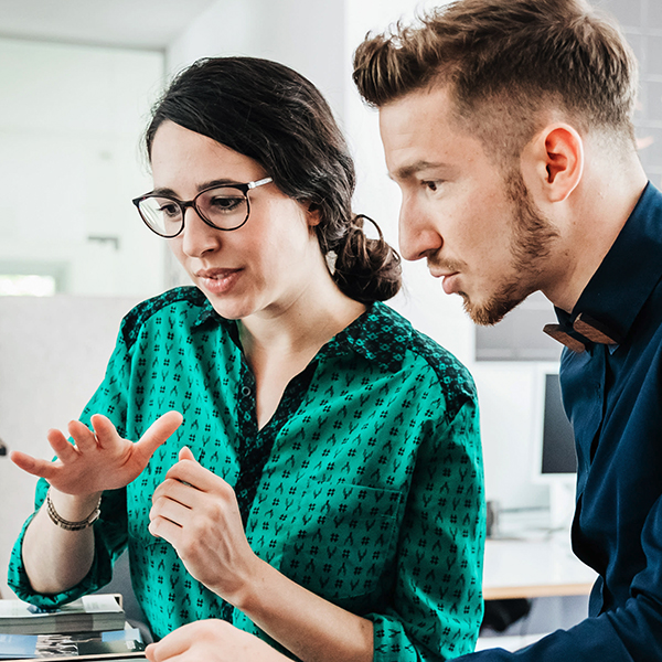 Man and woman looking at laptop