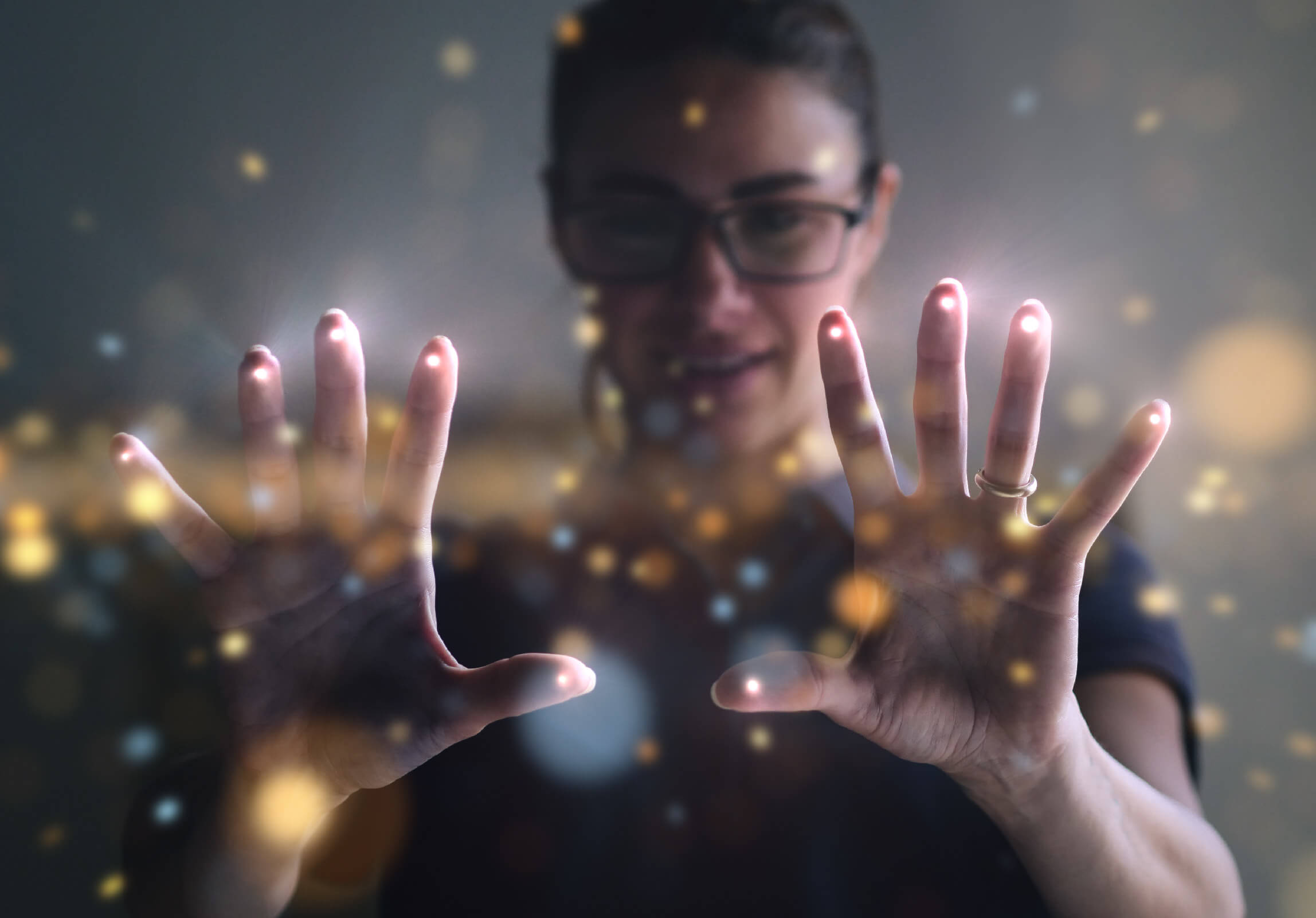 Woman with hands in front connected by golden dots
