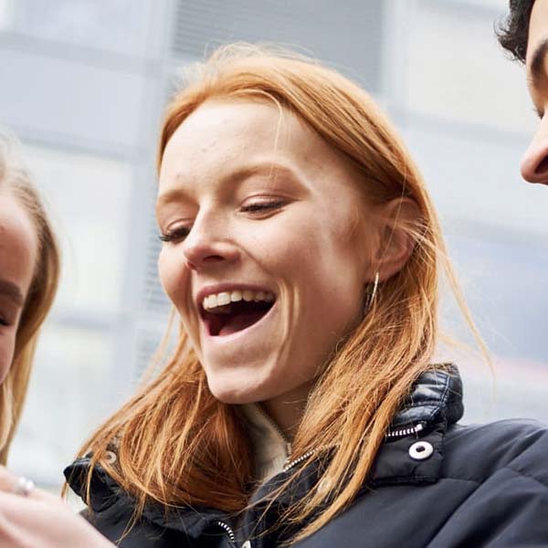 A woman smiling looking down