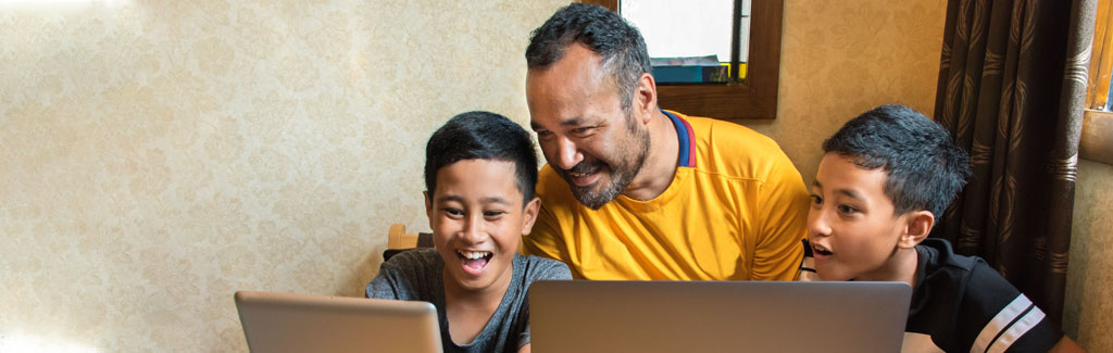 A family looking at computer screens
